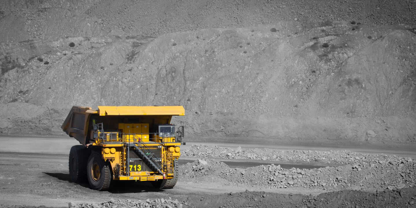 large yellow earth mover in quarry